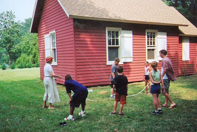 Visiting students playing outside of the schoolhouse